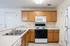 Inviting kitchen with sleek countertops, wooden cabinetry, and modern appliances for a seamless cooking experience.