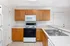 Bright and inviting kitchen with warm wooden cabinetry, modern appliances, and a spacious countertop layout.