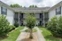 Charming apartment complex with well-manicured gardens, scenic balconies, and inviting courtyard views.