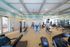 Bright and modern fitness center with top-of-the-line exercise equipment, mirrored walls, and natural lighting for an invigorating workout experience.