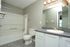 Modern bathroom showcasing elegant fixtures, a sleek vanity, and a spacious tub with contemporary design.