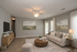 Inviting living room with plush beige sofa, elegant decor, soft lighting, and a cozy atmosphere, perfect for relaxation.