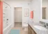 Elegant bathroom featuring a luxurious granite countertop, sleek fixtures, and modern decor with a vibrant coral theme.