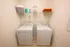 Modern laundry room with energy-efficient washer and dryer, organized shelving, and stylish decor.
