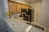Residents Snacking in the Kitchen | Apartment Homes In Williamsville | Renaissance Place Apartments