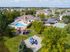 Aerial view of Windsong Place Apartments showing pool and playgrounds, sport court, and grounds Buffalo Apartments | Windsong Place Apartments