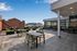 Chic rooftop terrace with modern seating, lush greenery, and stunning city views, perfect for relaxation and social gatherings.