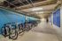 Spacious underground bike storage with sleek design and vibrant blue walls, perfect for urban living enthusiasts.