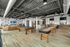Sleek and modern open-concept game room featuring billiards and shuffleboard, with inviting lounge area and stylish kitchen bar.