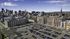 Vibrant urban skyline view with modern architecture and spacious parking area under a clear blue sky.