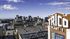 Breathtaking cityscape view from a luxury apartment building showcasing modern urban skyline and vibrant city life.