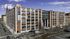 Impressive urban building with luxury apartments, featuring large windows and modern architecture, located on a bustling street with city views.