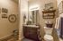 Another view of guest bathroom showing laundry area to the left of the vanity