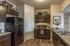 Vineyard, UT Apartments with In-Unit Washer and Dryer - Concord at Geneva - Kitchen with Wood-Style Flooring, Black Appliances, Flat-Panel Cabinets, Granite Countertops, and Dual Sink