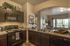 Closer view of stove, microwave, kitchen sink and breakfast bar, and dishwasher