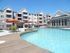 3 poolside lunch tables with umbrellas opened