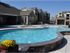 Pool and splash-pad in front of circular hot tub