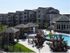 Overhead pool view showing pool house, two cabanas, and back of clubhouse