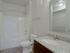Master bathroom with sink vanity, toilet, tub/shower combo, and walk-in closet entrance