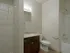 Full guest bathroom showing connected laundry area