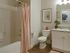 Guest bathroom with vanity sink, toilet, and bath/shower combo