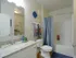 Master bathroom with sink vanity, toilet, tub/shower combo, and walk-in closet entrance