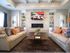 Office waiting room showing 2 couches, coffee table, fireplace, and television