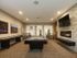 Game room with billiards table, flat screen television, fireplace, shuffleboard, and seating areas