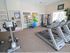 Fitness center showing the smith machine, band equipment, and exercise balls