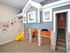 Playroom showing 2-level playhouse with slide and flat screen T.V.