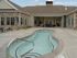 Apartments in Kansas City, Missouri, with In-Unit Washer and Dryer - Steeplechase - Large, Uniquely Shaped Hot Tub, Overlooking the Clubhouse with Sun Loungers and Outdoor Lounge Area.