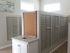 Indoor mail room with community pin-board and trash area