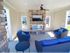 Pool cabana with flat screen television, fireplace, and 3 couches