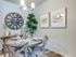 dining room with 4 person circular dining table and dishware credenza