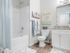 Upscale Apartments in Nampa, ID - The Station at Gateway - Bathroom with Shower/Tub Combo, Mirror, and Vanity with Sink and Granite Countertop.