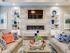 Clubhouse waiting room with two couches, coffee table, flat screen television, and fireplace