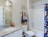 Master bathroom with sink vanity, toilet, tub/shower combo, and walk-in closet entrance