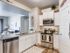 Kitchen with stainless steel dishwasher, double-sink, microwave, oven, stove, and fridge/freezer combo