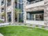 Apartment exterior showing patio overlooking grass area