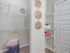 Master bathroom showing walk-in closet entry and shelving area