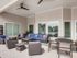 Two-Bedroom Apartments in Boise, ID - Kensington - Covered Outdoor Lounge With Sectional Seating, Coffee Tables, Ceiling Fan, and Oversized Windows Overlooking The Community Pool.