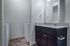 Guest bathroom showing entry to laundry area