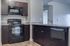 Kitchen area showing microwave, stove, oven, dishwasher, and double basin sink with pull out faucet.