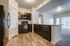 Wider angle of kitchen showing walk-in pantry and fridge/freezer combination, and ample counter space.