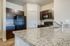 View of granite counter top peninsula and corner pantry