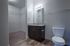 Master bathroom showing toilet, sink vanity, and entrance to walk-in closet.