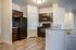 Another view of the kitchen showing appliance outlet in the counter peninsula with sink.
