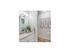 Guest bathroom showing vanity with white cabinets and laundry area entrance