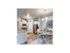 Open concept kitchen, dining, and living room with upgraded cabinets, lighting, hardware, and appliances