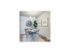 dining room with 4 person circular dining table and dishware credenza